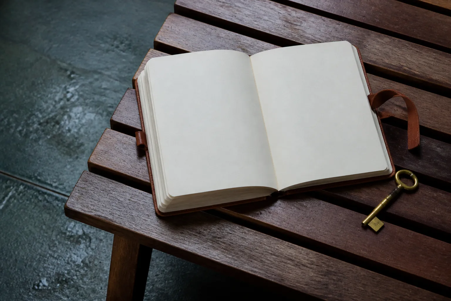 Open field notebook beside a brass locker key on a slatted wooden bench, damp stone floor at the edge of the frame, cool indoor light, no people, 1600x1000